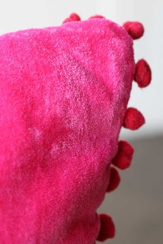 Close-up image of the Hot Pink Pom Pom Velvet Cushion