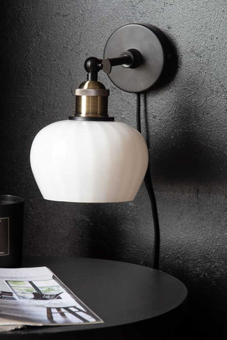 Lifestyle image of the Beautiful Glass Plug In Wall Light