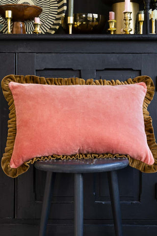 Lifestyle image of the Vintage Pink Velvet Cushion With Green Ruffle