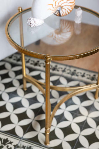 Detail shot of the Vintage-Style Gold & Glass Side Table, styled with some ornaments on the top.