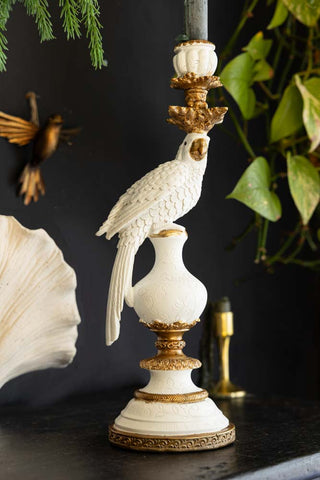 Lifestyle image of the Large White Ornate Parrot Candlestick Holder