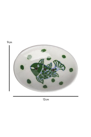Image of a cutout of a white and green fish soap dish in front of a white background with dimensions.