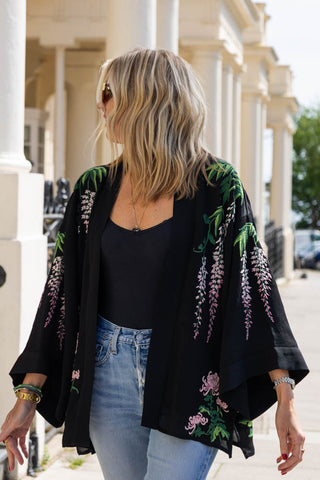 The Short Wisteria & Chrysanthemums Black Kimono being worn by a model.