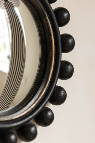 Close-up image of the Black Bobbin Convex decorative Mirror.