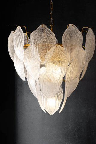 Lifestyle image of the Frosted Leaves Chandelier against a dark background.