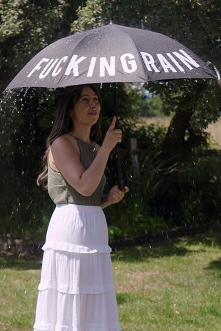 A black umbrella in a festival setting