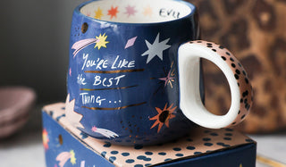 The You're Like The Best Thing Mug displayed on its packaging on a kitchen worktop.