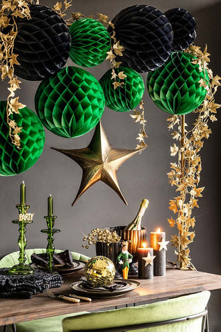 Tablescape styled with black and green honeycomb balls