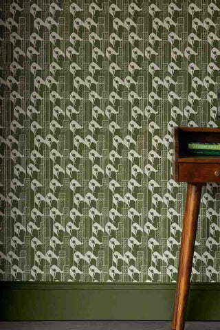 Close up image of Rockett St George Olive Green wallpaper. The Margot wallpaper features a beautiful lady on a NYC backdrop. 