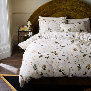 The Jane's Rose Duvet Cover and Pillow Case Set displayed on a bed in a bedroom, styled with various home accessories.