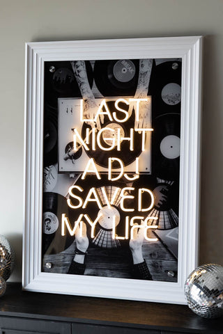 The Last Night A DJ Saved My Life... Framed Neon Wall Light with a white frame styled against a white wall.