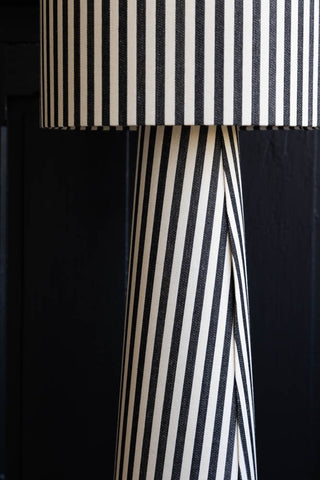 Detail image of the Black & White Stripe Floor Lamp with a black cabinet