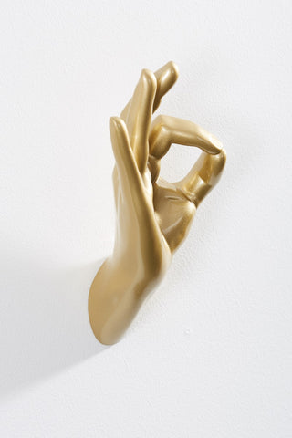Image of the Gold Okay Hand Wall Art & Coat Hook on a white wall