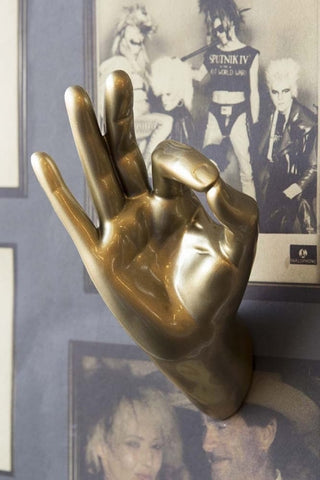 Lifestyle image of the Gold Okay Hand Wall Art & Coat Hook