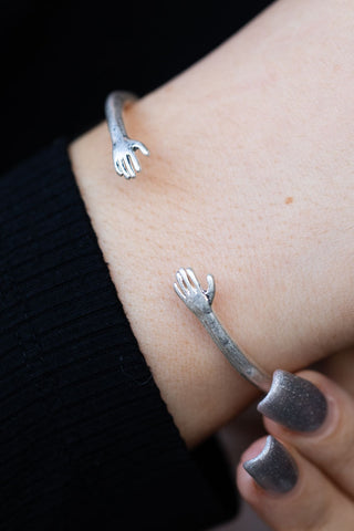 Close-up image of the Adjustable Silver Hugs Bangle