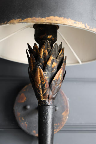 Close-up image of the leaf detail on the Aged Effect Black & Old Gold Torch Wall Light