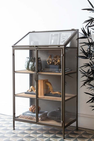 Lifestyle image of the Antique Brass Glass Display Cabinet with the doors closed