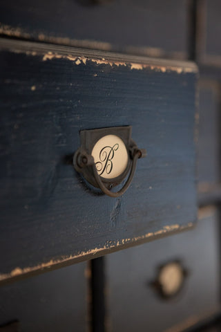 Close-up image of the drawer and knob on the Antique Style Black Multi-Drawer Storage Cabinet