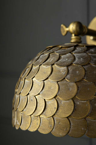 Close-up image of the Antique Brass Scalloped Plug In Wall Light