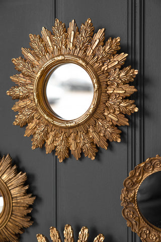 Lifestyle image of the Antique Gold Ornate Leaf Small round Mirror
