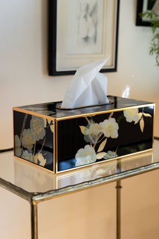 Image of the black and gold tissue box styled on glass shelves