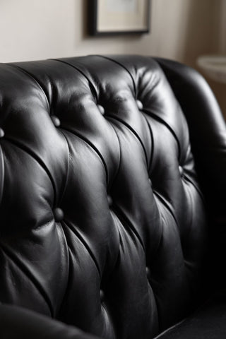 Close-up image of the Black Buttoned Back Leather Armchair