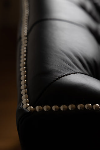 Image of the finish for the Black Buttoned Back Leather Armchair