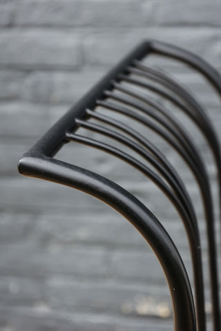 Close-up image of the arm of the Black Metal Garden Bench