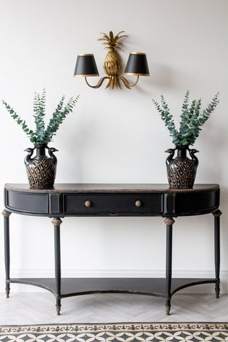 Front-on lifestyle image of the Black Vintage Style Metal Distressed Console Table With Drawer