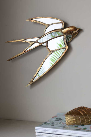 Close-up lifestyle image of the Brass & Mirror Swallow Wall Decoration