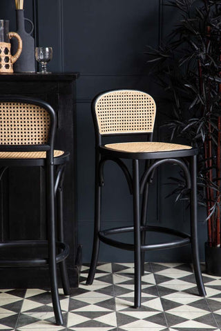 Lifestyle image of the Chez Pitou Black Wood & Woven Cane Bar Stool