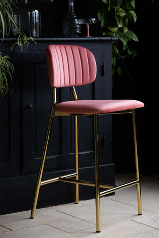 Lifestyle image of the Coral Pink Velvet Bar Stool With Gold Legs