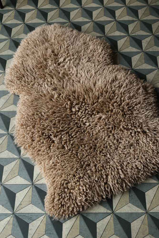 Image of the Curly Sheepskin Rug In Butterscotch on the floor