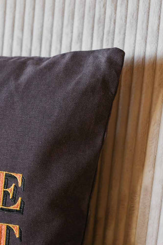 Detail image of the Dare To Be Different Embroidered Brown Cushion fabric