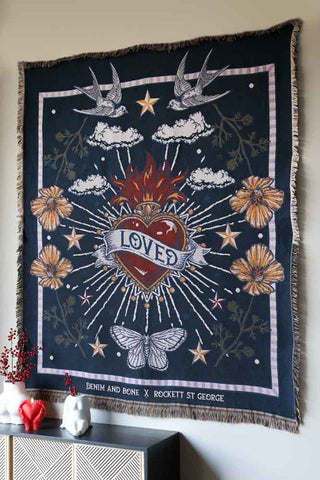 Image of the Denim & Bone Midnight Blue Loved Woven Cotton Throw hanging on a wall