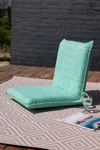 Lifestyle image of the Folding Garden/Beach Chair In Cool Mint