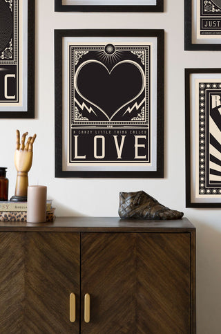 Lifestyle image of the Framed Crazy Little Thing Called Love Art Print hanging on the wall