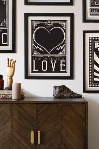 Lifestyle image of the Framed Crazy Little Thing Called Love Art Print hanging on the wall