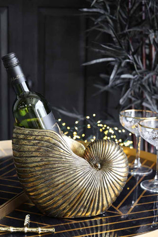 Image of the Gold Shell Planter used as a bottle holder