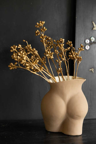 Close-up image of the Gorgeous Gold Dried Mini Seed Pods on a dark background in a bum vase