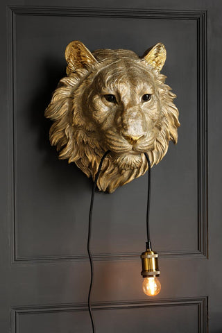 Angled image of the Lion Head Wall Light with the light on