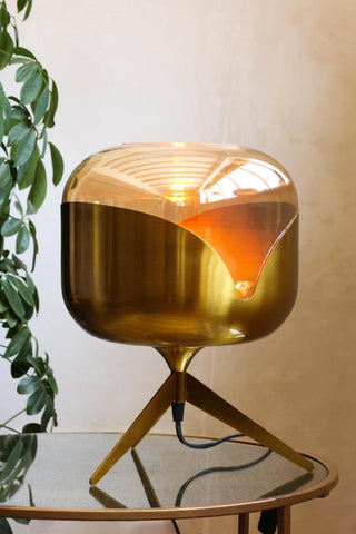 Image of the Retro Golden Glass Tripod Table Lamp lit up