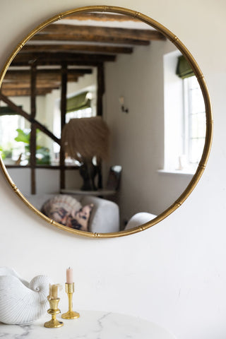 Lifestyle image of the Round Antique Gold Wall Mirror