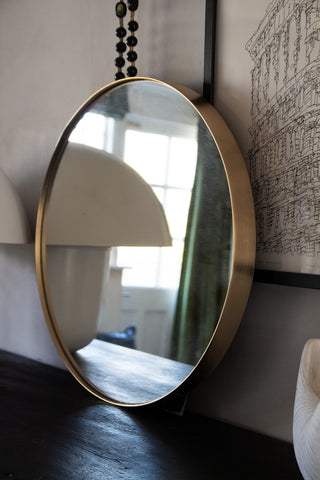 Beautiful bathroom mirror resting against a wall.