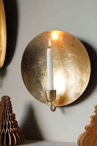 Festive lifestyle image of the Round Gold Leaf Candlestick Holder Wall Sconce