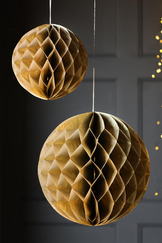 Lifestyle image of the Set Of 2 Gold Honeycomb Ball Decorations