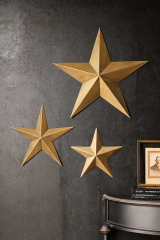 Lifestyle image of the Set Of 3 Antique Gold Metal Stars