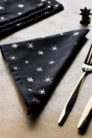 Lifestyle image of the Set Of 4 Dark Grey Napkins With Gold Stars