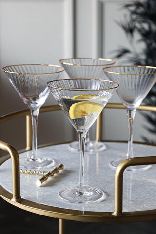 Lifestyle image of the Set Of 4 Ribbed Martini Glasses With Gold Rim