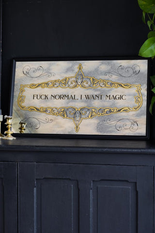 Lifestyle image of a rectangular mirror with the words, 'Fuck Normal, I Want Magic' written on it. A beautifully decorative typography mirror.